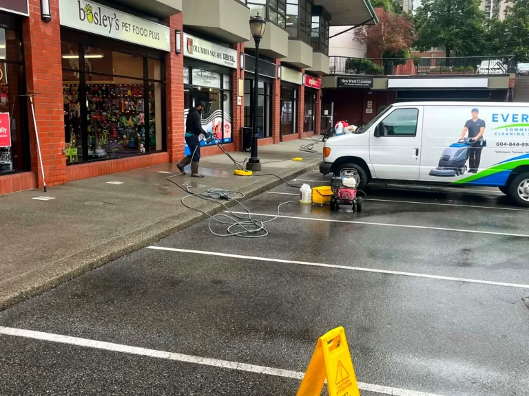 Everest cleaning van parked in a lot while crew pressure wash the pavement