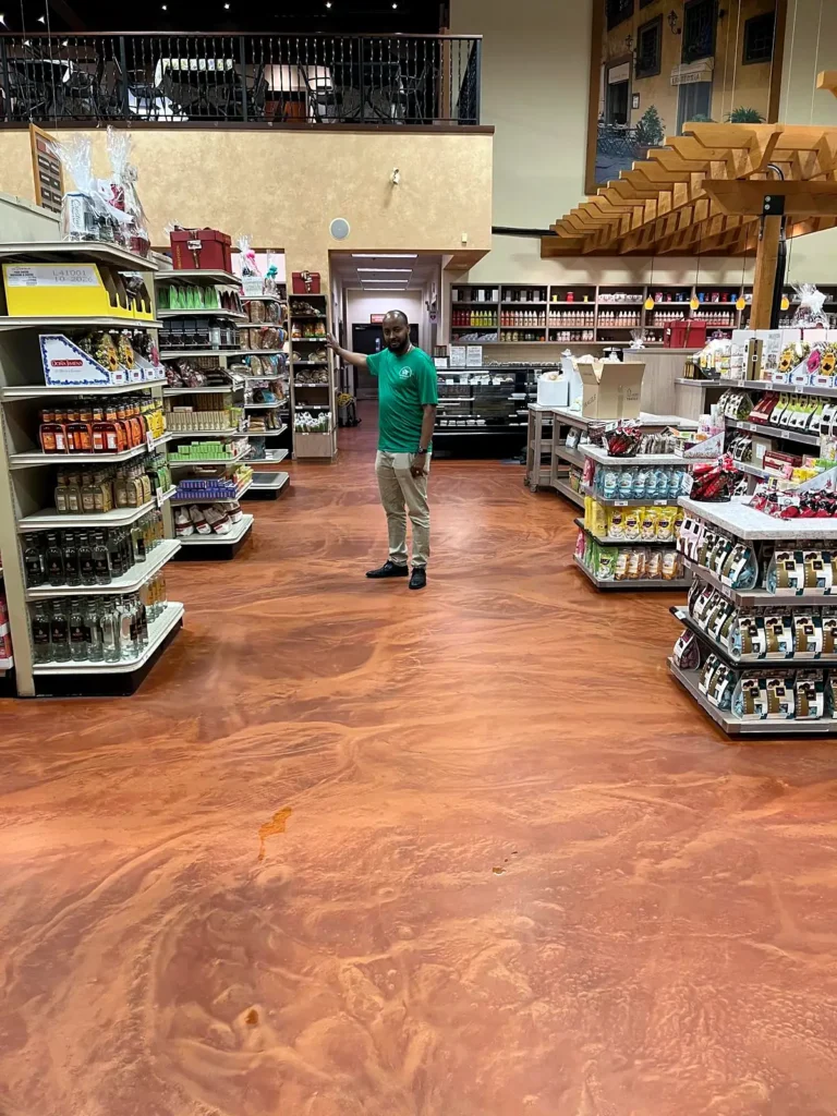 Everest crew member standing in a Bosa Foods aisle on a polished copper epoxy floor