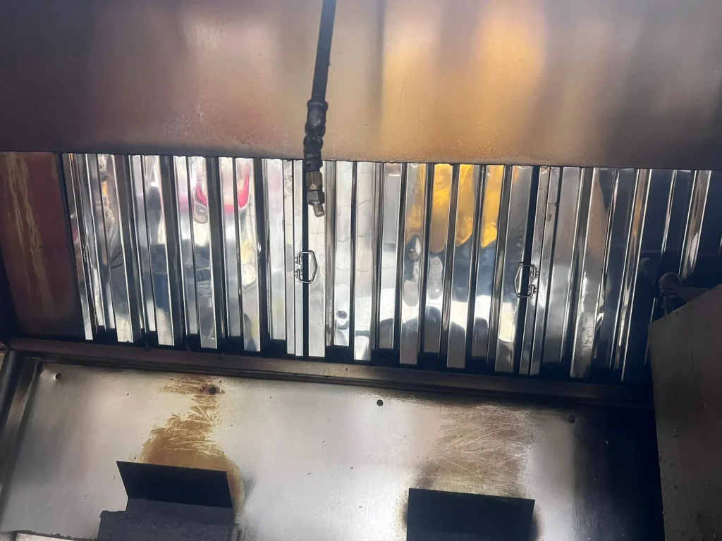 After: kitchen exhaust hood with clean baffle filters and drip tray