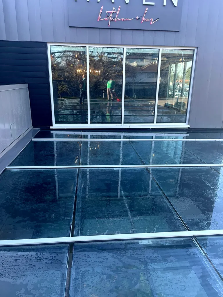 Glass canopy roof in front of the Haven kitchen+bar storefront