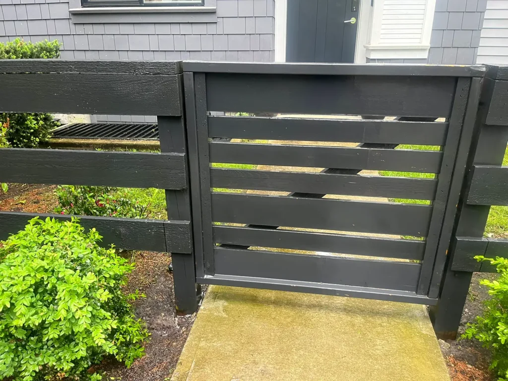 After: cleaned wooden gate and concrete path at a townhouse complex