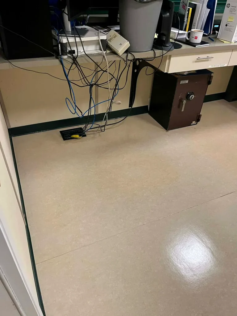 After: glossy stripped and waxed VCT floor in the same office corner